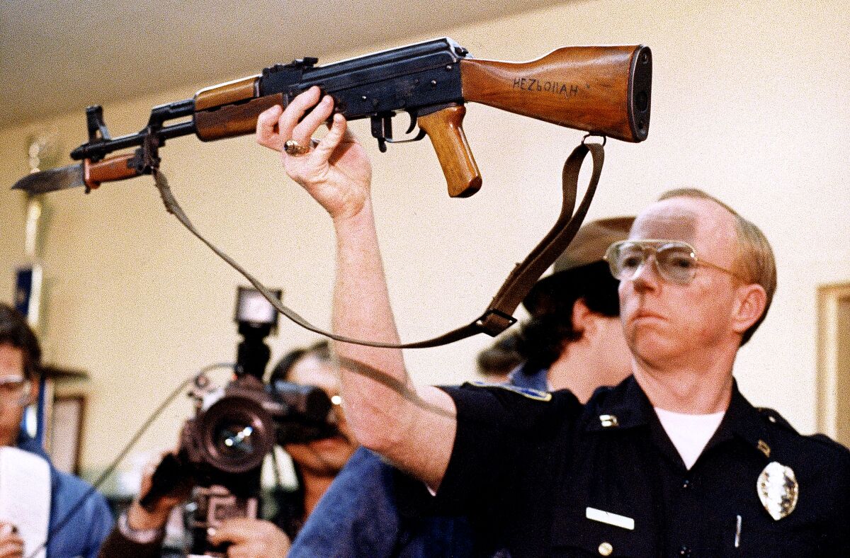 Stockton Police Captain J.T. Marnoch holds up a Chinese-made AK-47 assault rifle in 1989