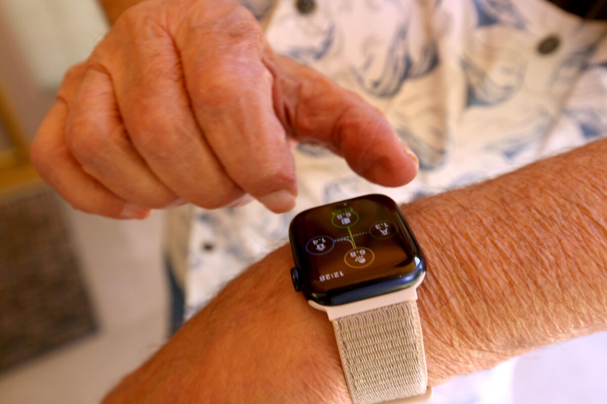 Ken Mattlin adjusts his Apple watch at his home in Bakersfield.