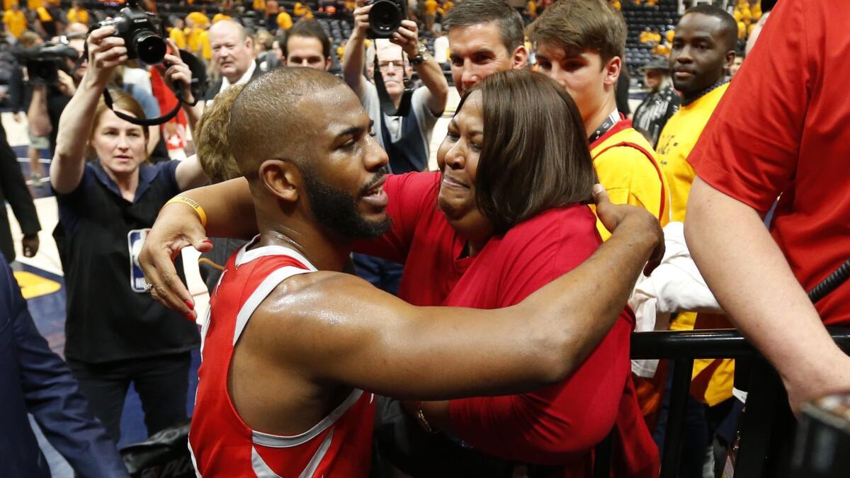 Rockets guard Chris Pau receives a hug from his mother following Game 4 of the playoff series against the Jazz.