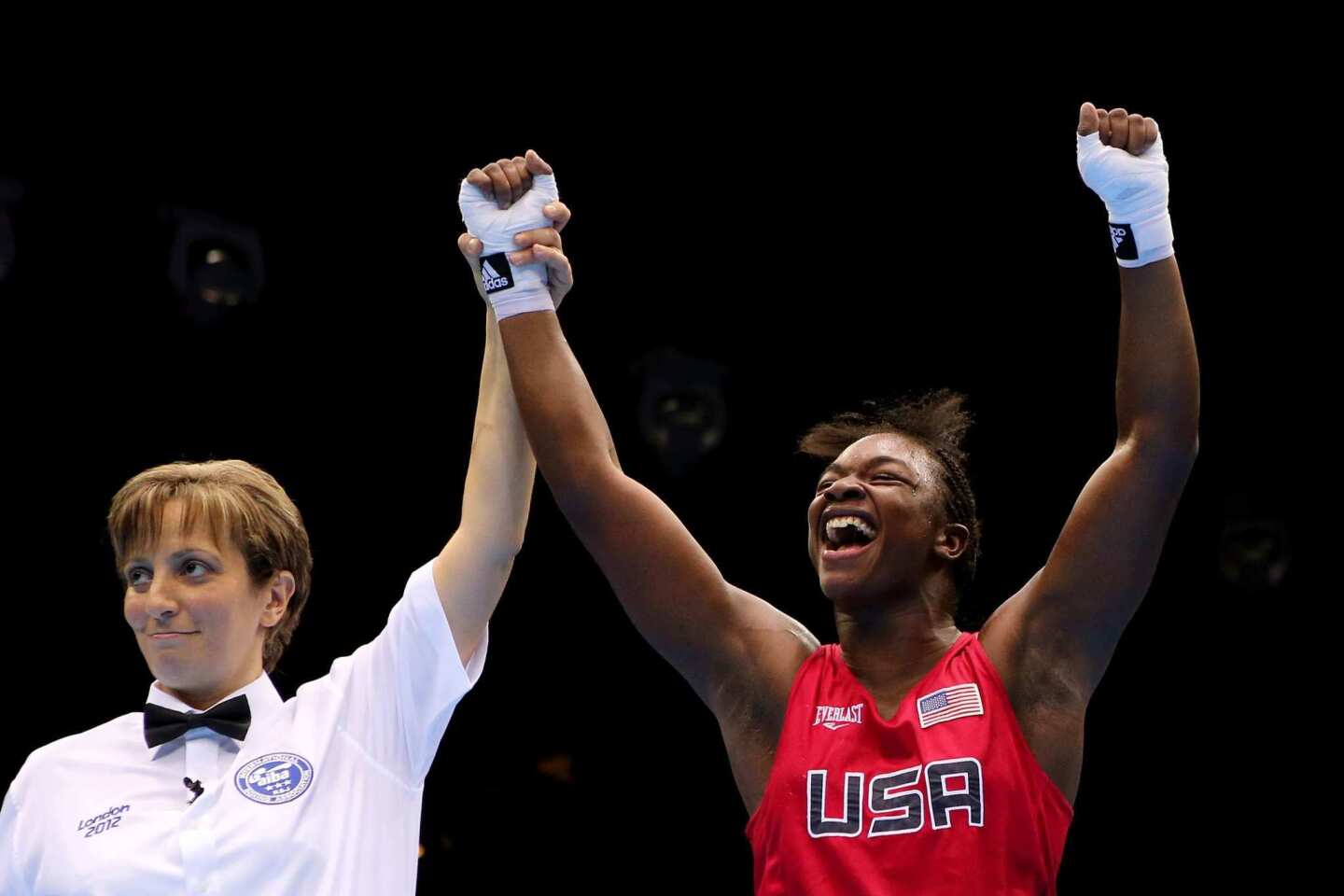 Referee Kheira Sidi Yakoub, left, announces Claressa Shields of the United States as the winner in the women's middleweight championship bout, giving her the historic first gold in the sport's Olympic debut.