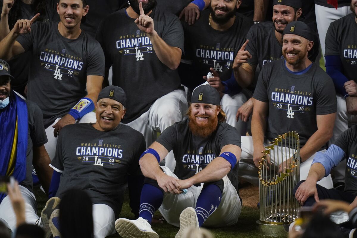 The Dodgers pose for a team photo with the World Series trophy.