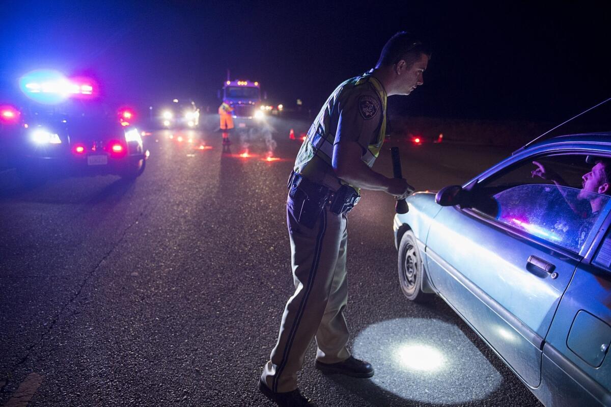California Highway Patrol Officer Ken Weckman directs traffic as residents evacuate Marysville on Sunday.