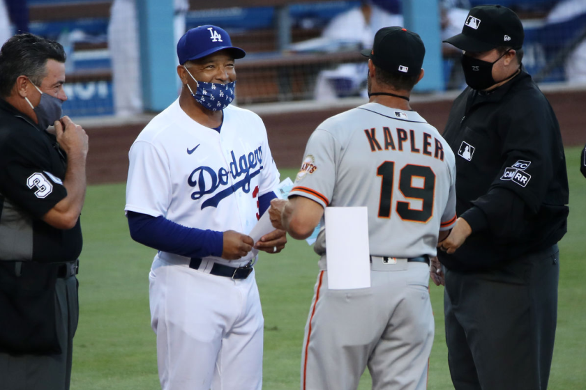 LOS ANGELES, CALIFORNIA - JULY 26: Manager Dave Roberts #30 of the Los Angeles Dodgers and Manager Gabe Kapler.