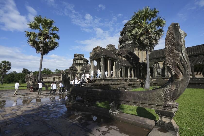 Tourists visit the Angkor Wat temple in Siem Reap, Cambodia, Wednesday, Nov. 15, 2023. It's believed Cambodia's main tourist destination, Angkor Wat, was built between the 9th and 15th centuries. (AP Photo/Heng Sinith)