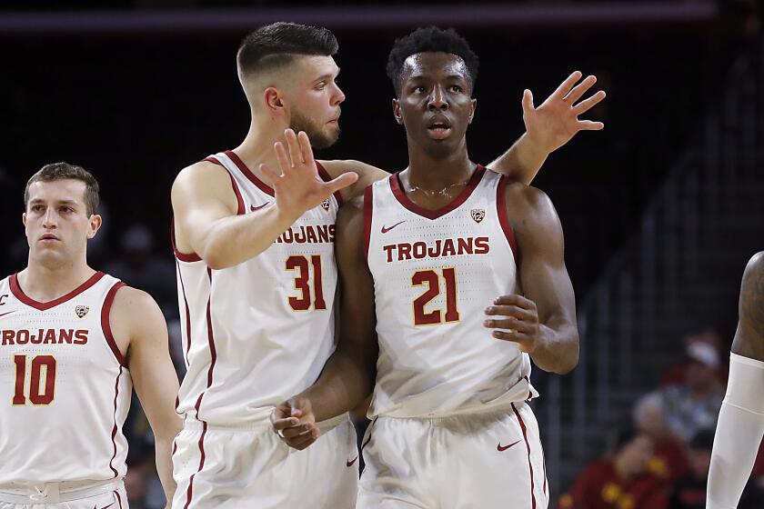 LOS ANGELES, CALIF. - NOV. 19, 2019. USC big men Nick Rakocevic and Onyeka Okongwu habe an oncourt chat in the first half at the Galen Center in Los Angeles on Tuesday might, Nov. 19, 2019. (Luis Sinco/Los Angeles Times)