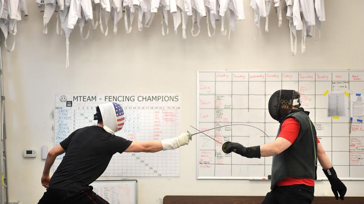 Greg Massialas, right, and his son Alex practice at Massialas Foundation Fencing Club in San Francisco. Dad is a three-time Olympian and current U.S. national coach and son is an Olympic medalist and former NCAA champion at Stanford.
