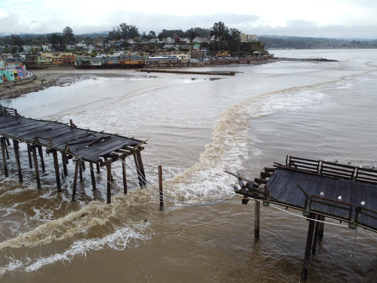 A pier is split in two in high water.