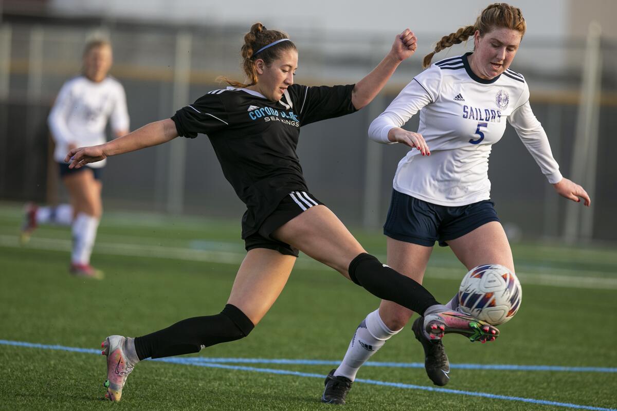 Corona del Mar's Isabella Thomas kicks a ball past Newport Harbor's Stella Gaffney during Thursday's match.