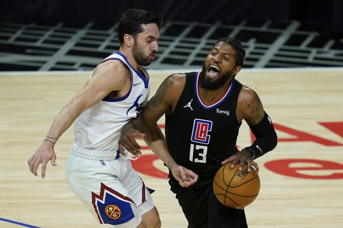 Paul George is fouled by Nuggets guard Facundo Campazzo.