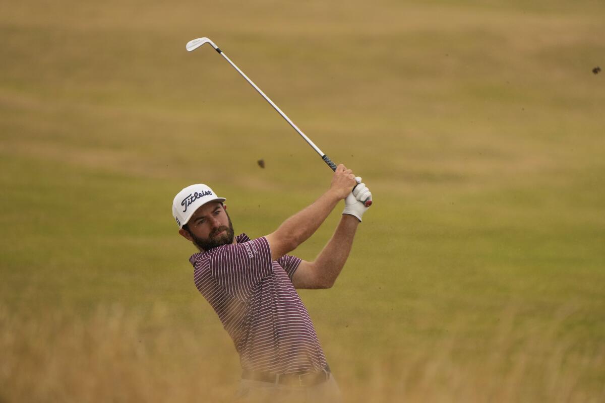 Cameron Young takes a swing from the rough on the 13th fairway at the British Open on Sunday.