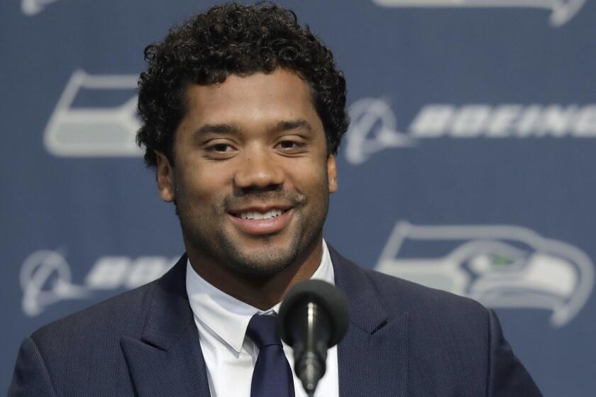 Seattle Seahawks NFL football quarterback Russell Wilson talks to reporters Wednesday, April 17, 2019, in Renton, Wash. Earlier in the week, Wilson signed a $140 million, four-year extension with the team. (AP Photo/Ted S. Warren)