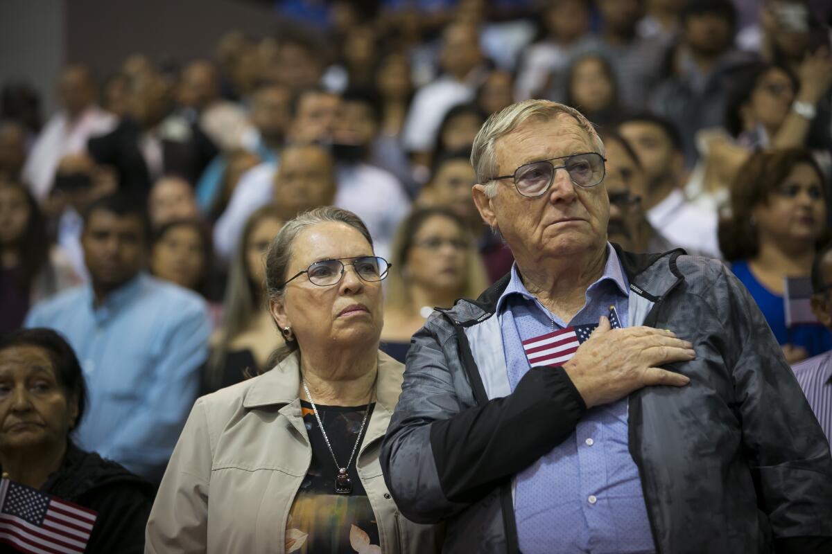 Hans Gottwald, with wife Margie, takes his oath of allegiance in Houston.
