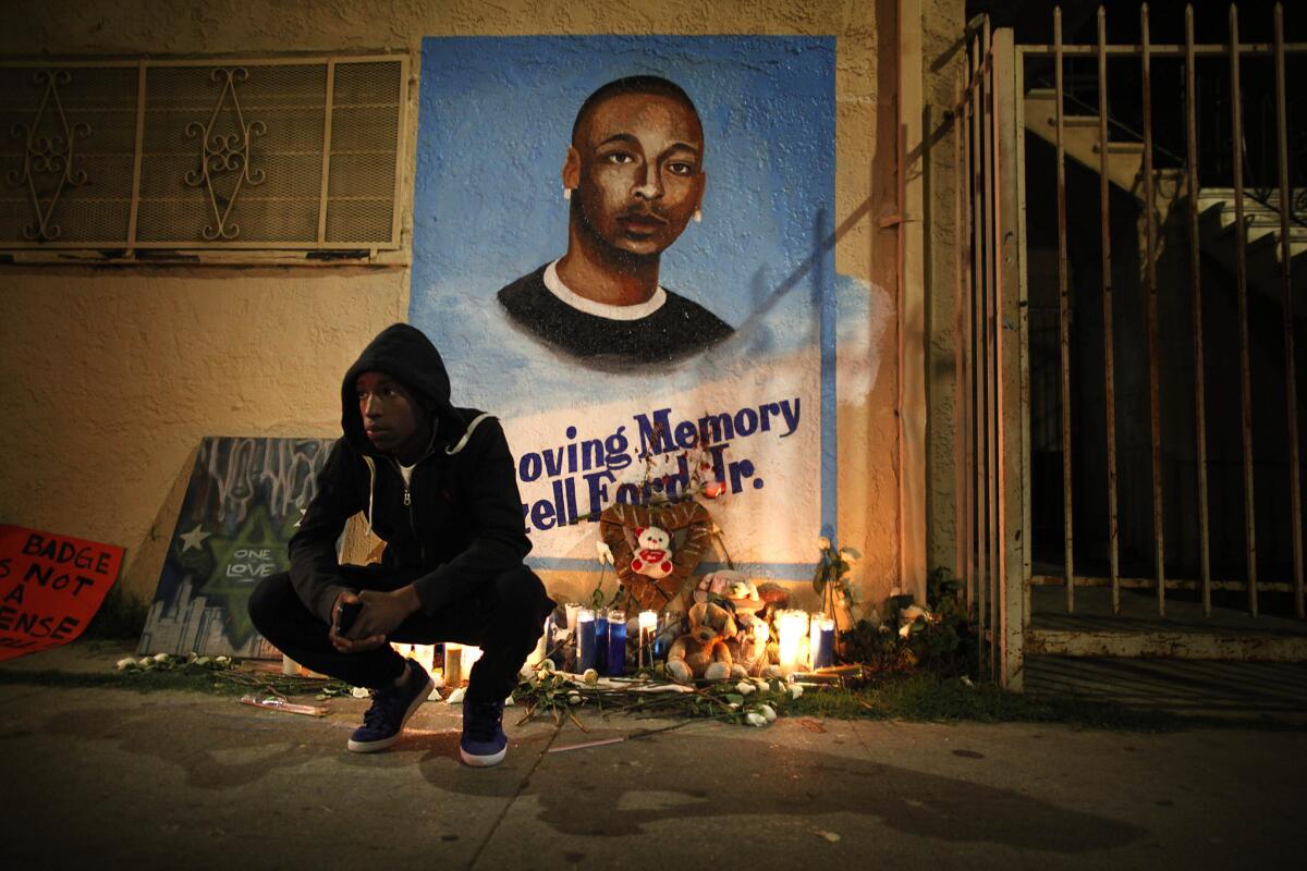 A mourner outside a memorial for Ezell Ford several months after he was fatally shot by LAPD officers near his South L.A. home in August 2014.