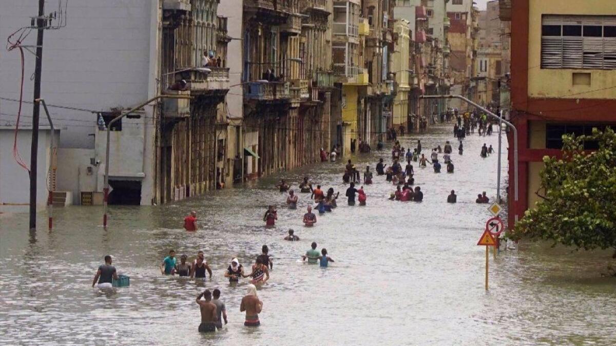 People move through flooded streets in Havana after the passage of Hurricane Irma on Sept. 10.