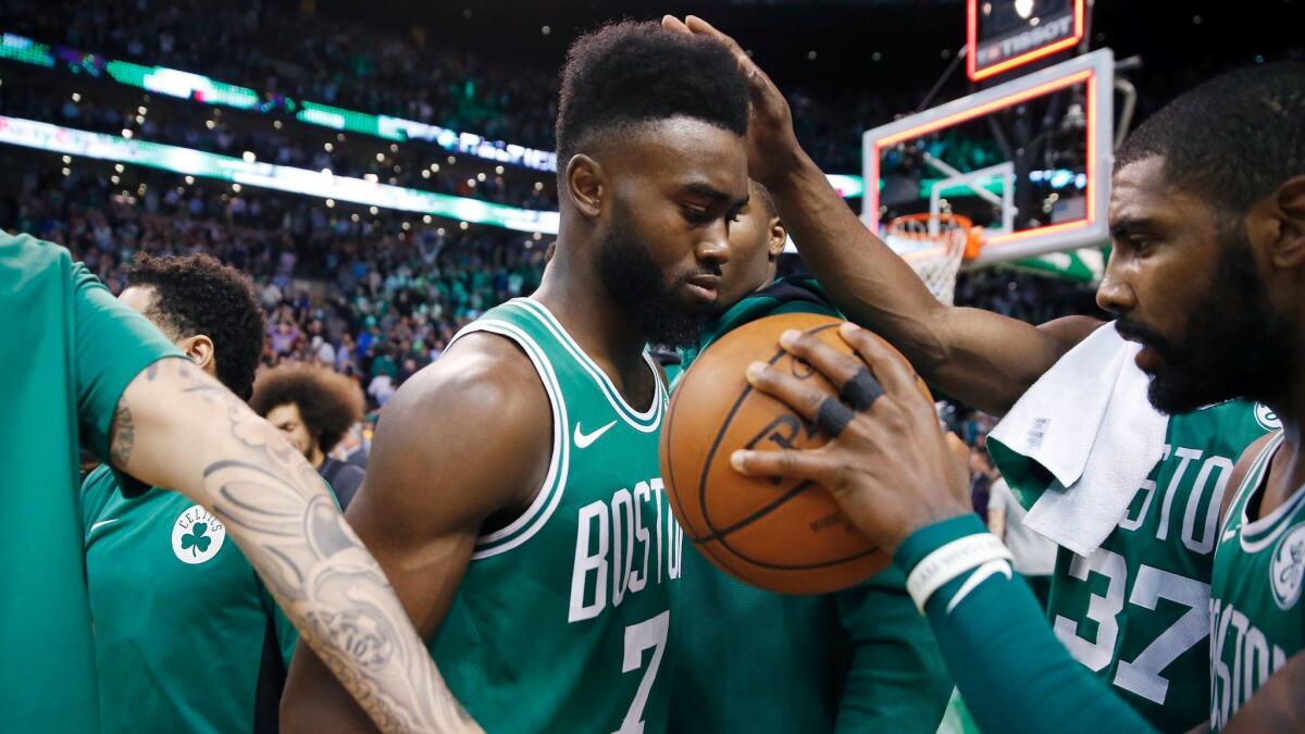 Boston's Jaylen Brown gets the game ball from teammate Kyrie Irving after the Celtics defeated the Golden State Warriors on Nov. 16.