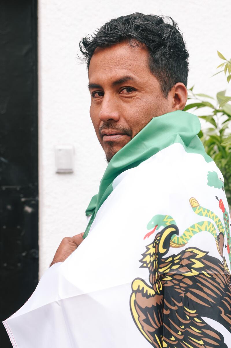 Antonio Guerrero takes a portrait while waiting to vote outside the Mexican Consulate.