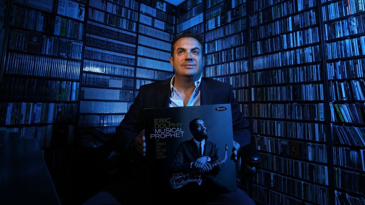 Zev Feldman, executive vice president and general manager of Resonance Records, holds a copy of his recently produced "Eric Dolphy: Musical Prophet, against a backdrop of CDs at his Los Angeles office.