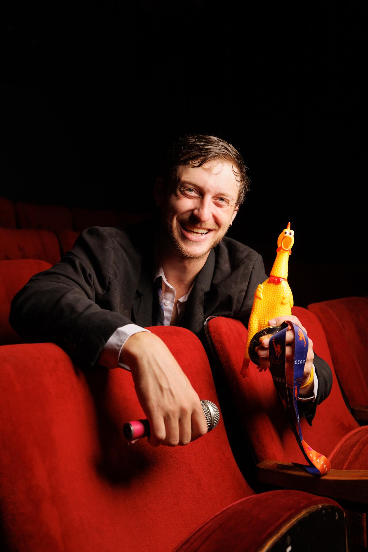 Zach Zucker holds up a rubber chicken.