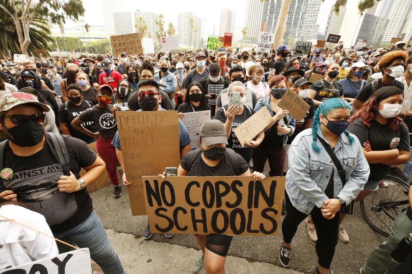 LOS ANGELES, CA - JUNE 16: Students and community members listen to speakers on the steps of LAUSD headquarters urging LAUSD to defund school police and eliminate their budget. Los Angeles on Tuesday, June 16, 2020 in Los Angeles, CA. (Al Seib / Los Angeles Times)