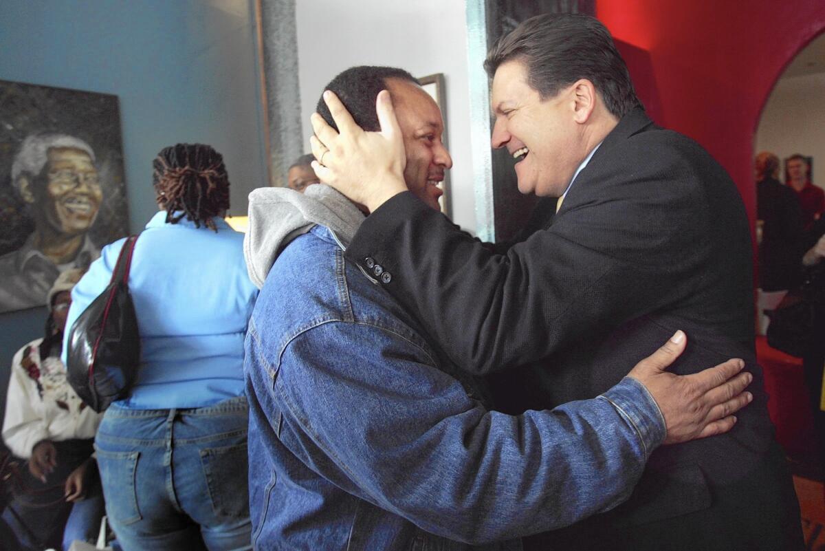 Former Assembly Speaker Bob Hertzberg greets community activist Najee Ali at a coffeehouse in Los Angeles in 2005.