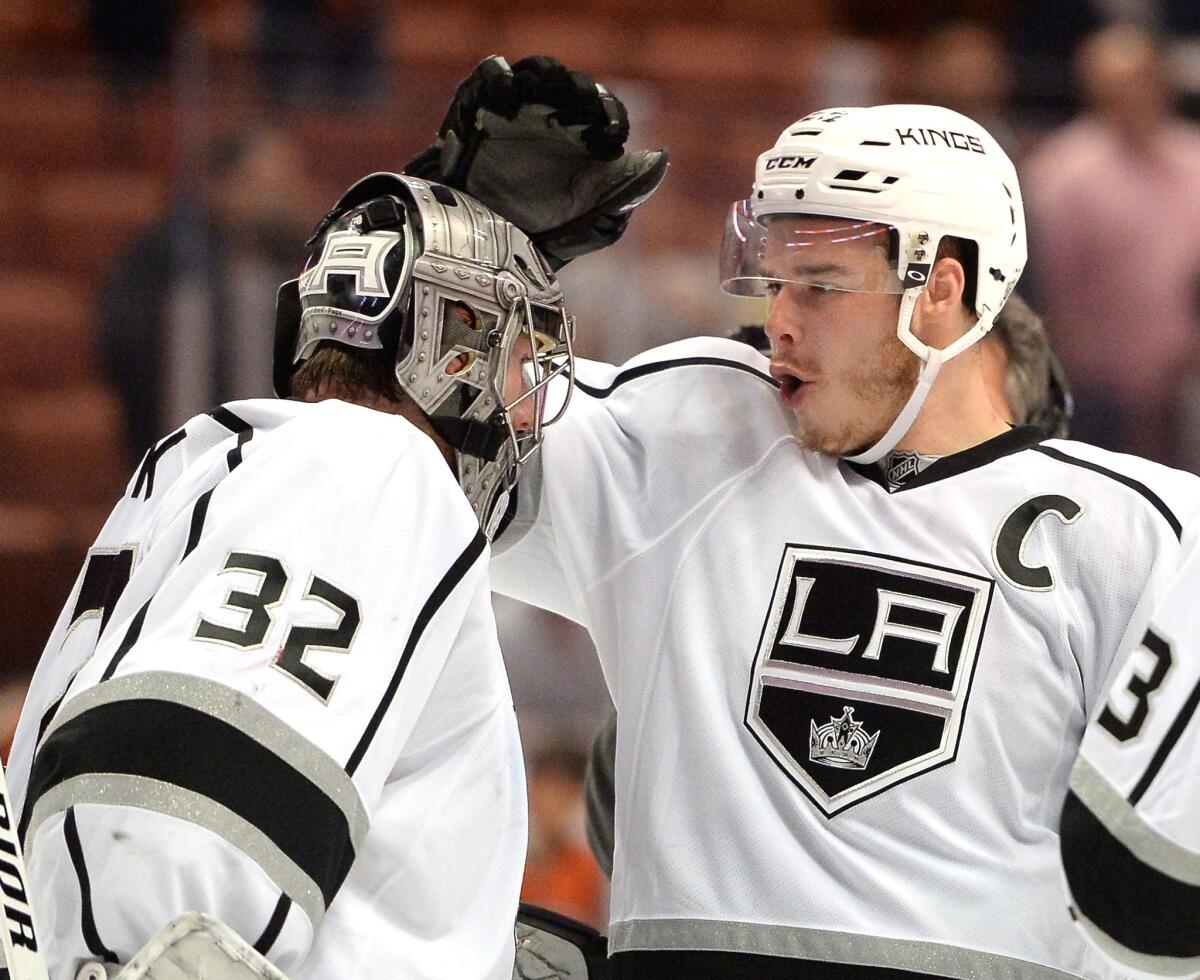 The Kings' Dustin Brown, right, celebrates Game 2 win over the Ducks with goaltender Jonathan Quick, left, on May 5.
