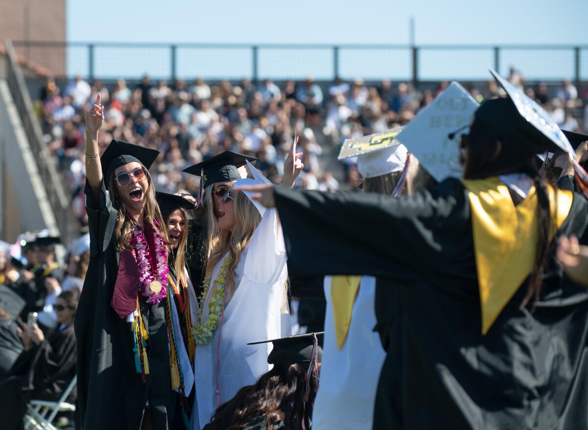 Seniors shout with excitement during their graduation ceremony at Huntington Beach High on Wednesday.