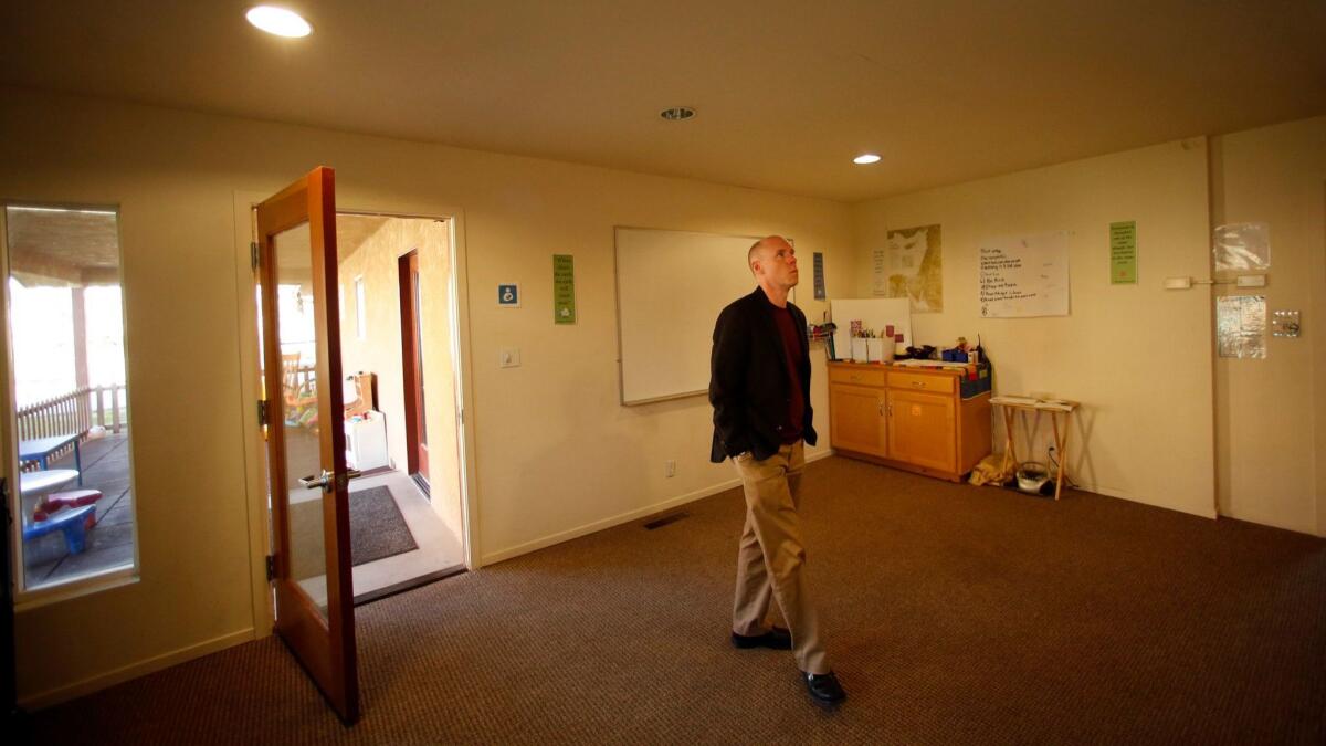 The Rev. Tim Kutzmark of the Unitarian Universalist Church of Fresno walks through a room at the church that will be offered as sanctuary to an undocumented individual or family if members approve. (Genaro Molina / Los Angeles Times)