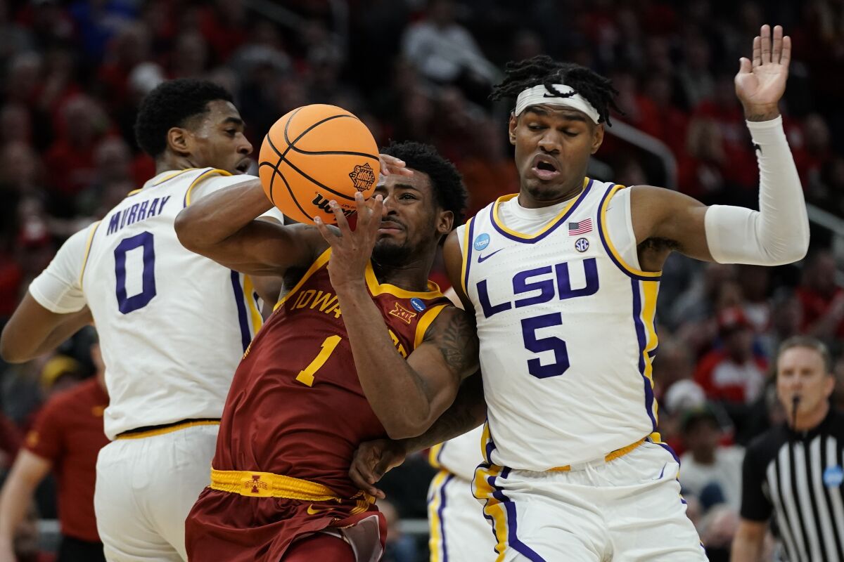 Iowa State's Izaiah Brockington is fouled as he drives between LSU's Brandon Murray and Mwani Wilkinson during the second half of a first round NCAA college basketball tournament game Friday, March 18, 2022, in Milwaukee. (AP Photo/Morry Gash)
