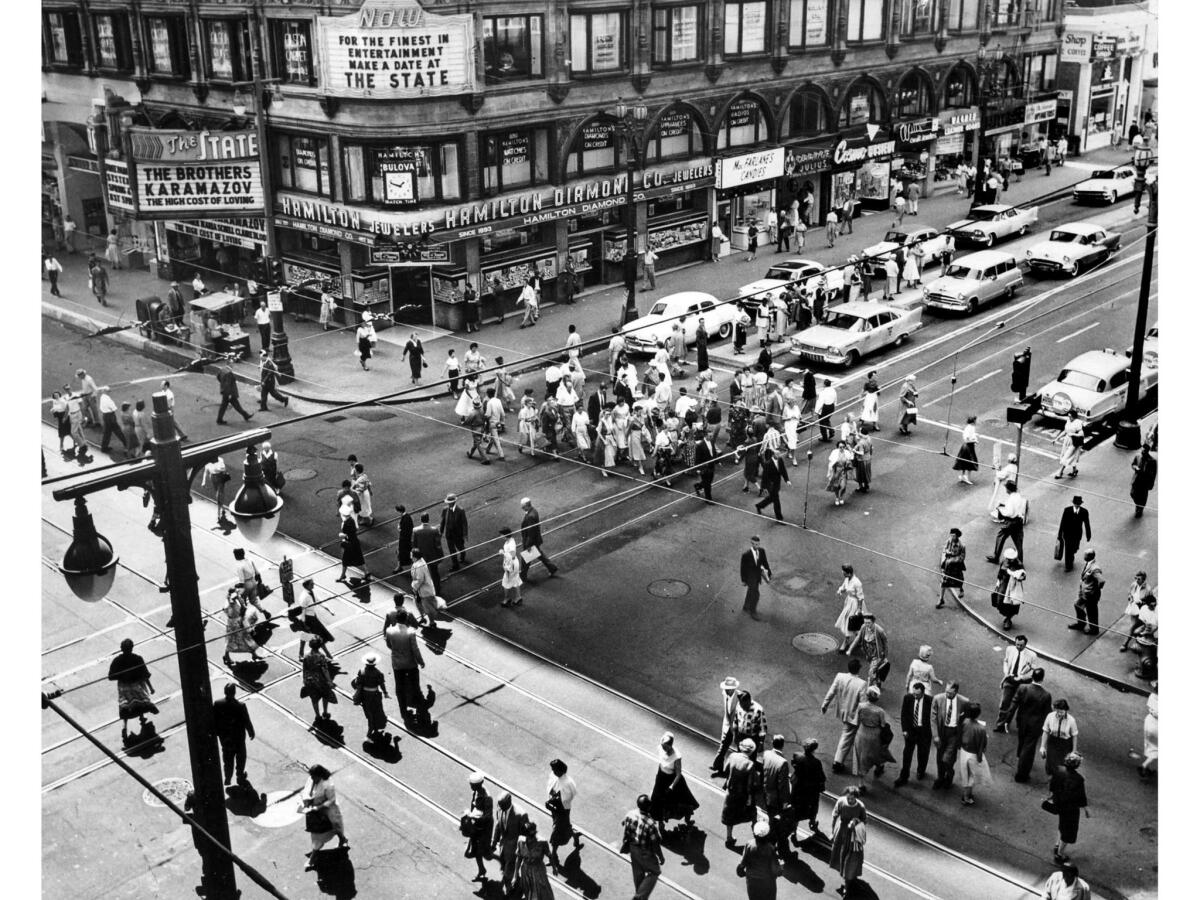 April 1958: Pedestrian traffic at 7th and Broadway about noon. According to a short Los Angeles Times article of April 16, 1958, the movies "The Brothers Karamazov" and "The High Cost of Loving'" opened at the State Theatre that day.