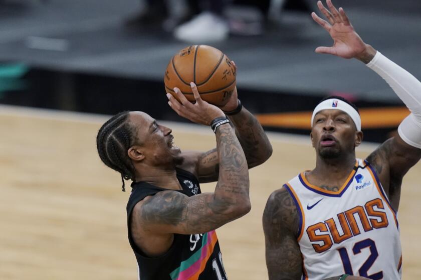 San Antonio Spurs forward DeMar DeRozan (10) shoots over Phoenix Suns forward Torrey Craig (12) during the second half of an NBA basketball game in San Antonio, Sunday, May 16, 2021. (AP Photo/Eric Gay)