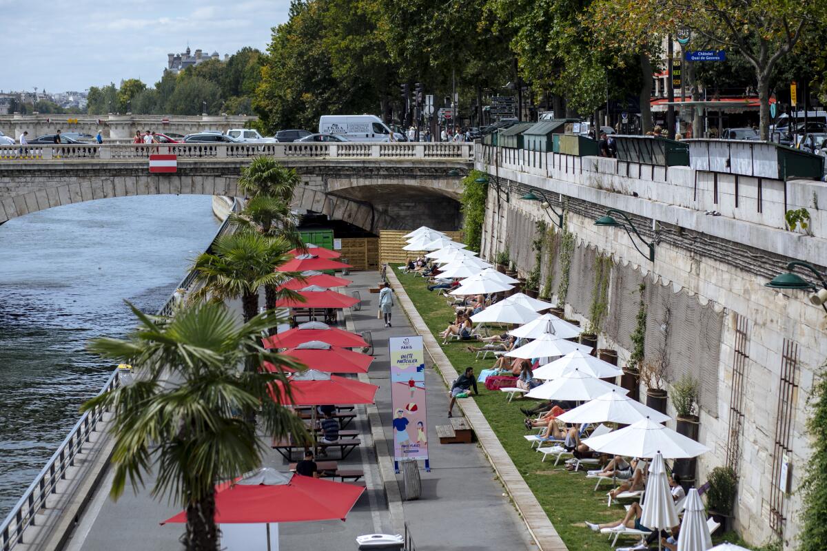 People sunning along the river Seine in Paris