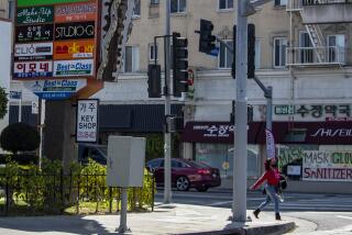 LOS ANGELES, CA - MARCH 18: Street scene on Western Ave. in Koreatown on Thursday, March 18, 2021 in Los Angeles, CA. (Brian van der Brug / Los Angeles Times)