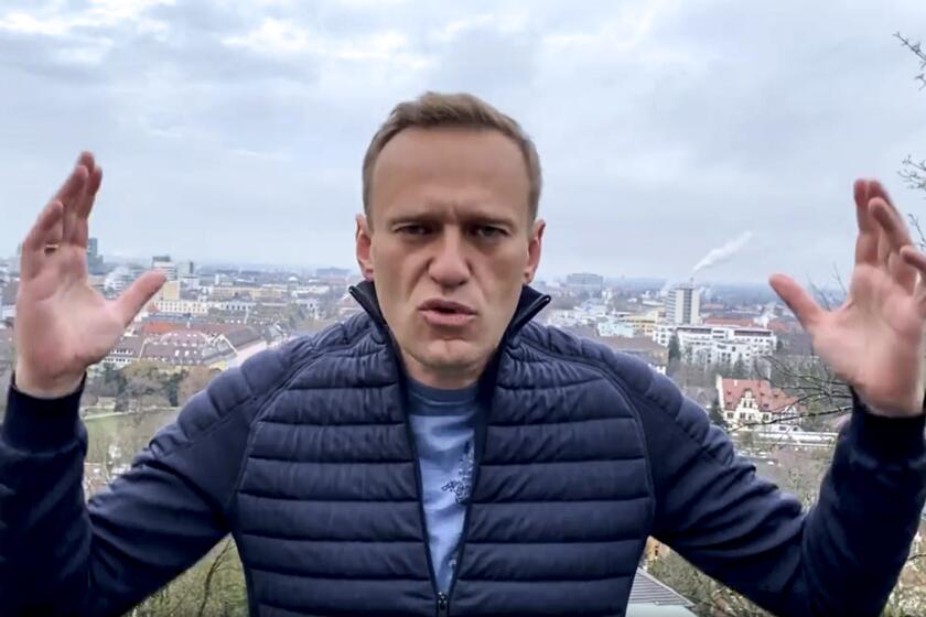 In this handout photo taken from a video released on Wednesday, Jan. 13, 2021, by Russian opposition activist Alexei Navalny in his instagram account, Russian opposition activist Alexei Navalny gestures as he records his address. Top Kremlin critic Alexei Navalny says he will fly home to Russia over the weekend despite the Russian prison service's latest motion to put him behind bars for allegedly breaching the terms of his suspended sentence and probation. (Navalny instagram account via AP)