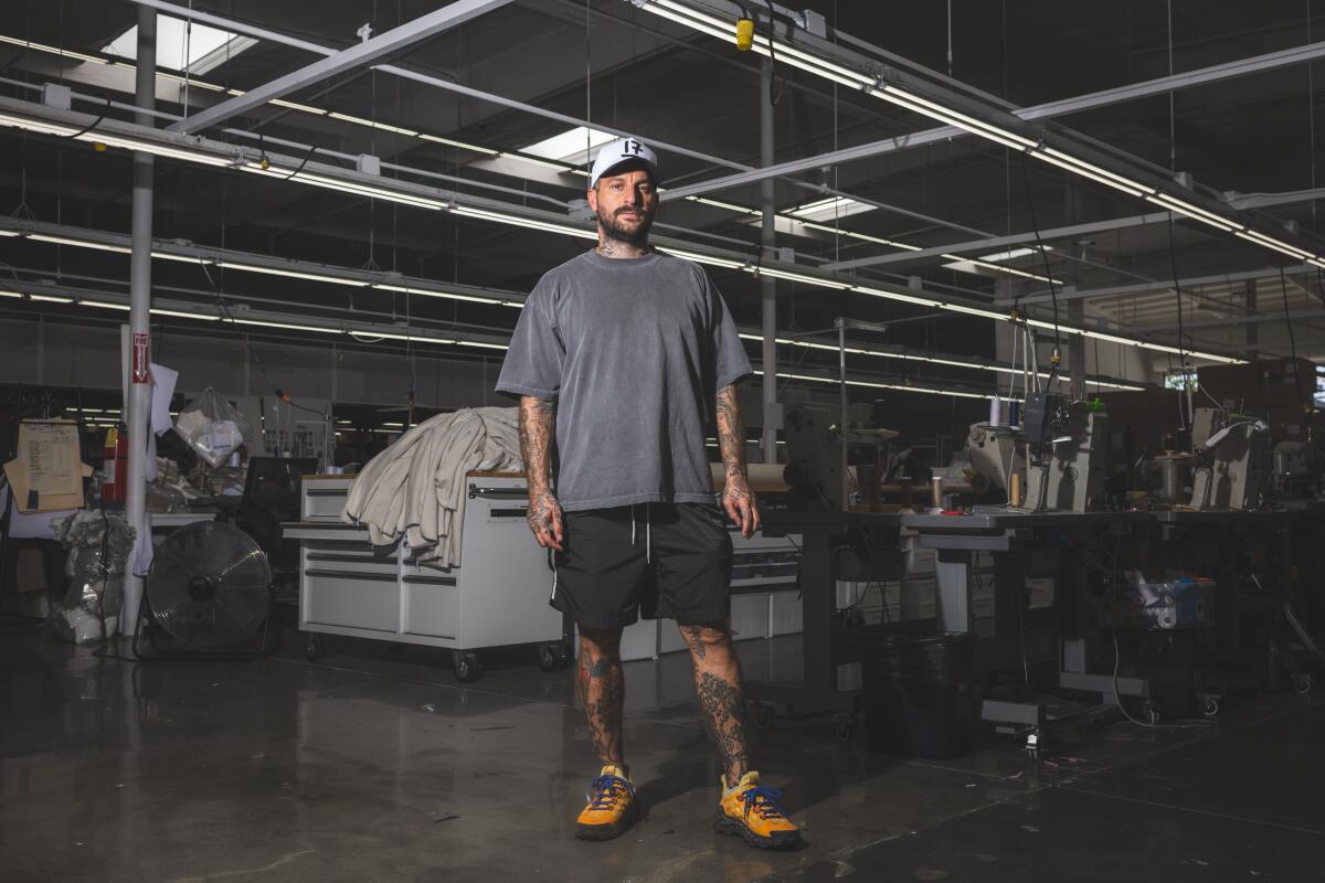 A photo of Dominic Ciambrone, aka the Shoe Surgeon, posing for a portrait at his factory.