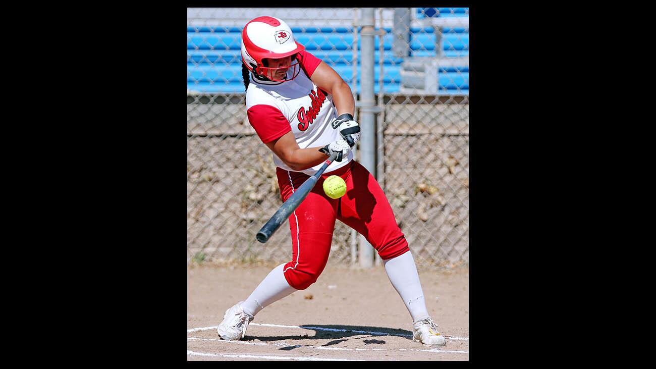 Burroughs High softball player #5 Chloe Bookmeyer connects with the ball in home game vs. Crescenta Valley High, at Olive Park in Burbank on Tuesday, April 24, 2018.