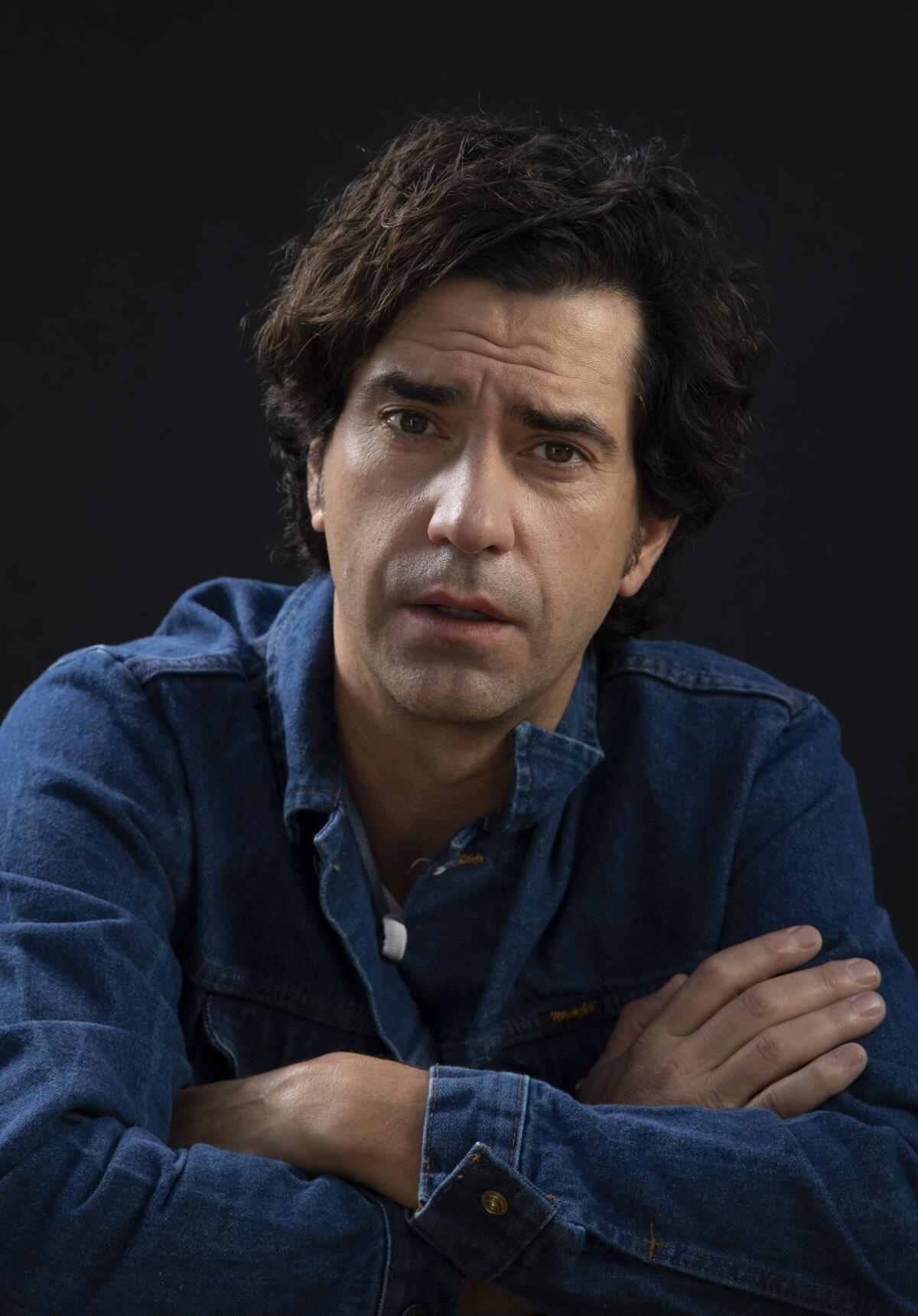 "Midnight Mass" star Hamish Linklater in a blue shirt.