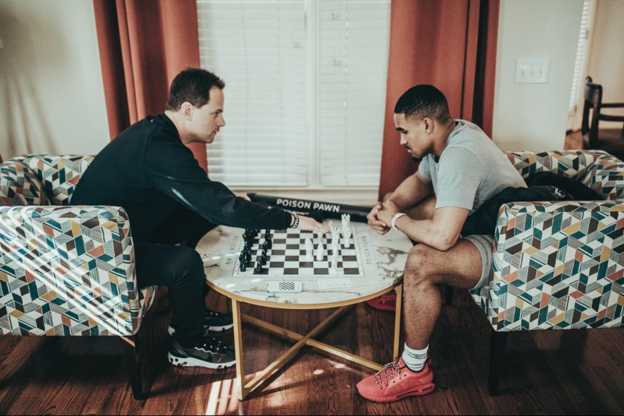 Seth Makowsky, left, plays chess with Jalen Hurts, current quarterback of the Philadelphia Eagles.