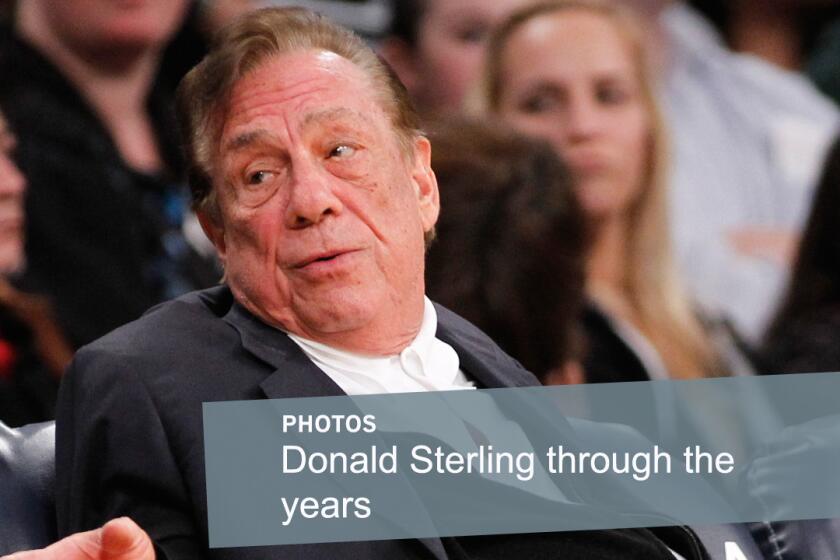 Former Clippers owner Donald Sterling gestures while attending a game between the Clippers and Lakers in December 2011. Sterling lost his legal fight to prevent the sale of the Clippers after remarks he made about blacks led to a lifetime ban from the NBA.