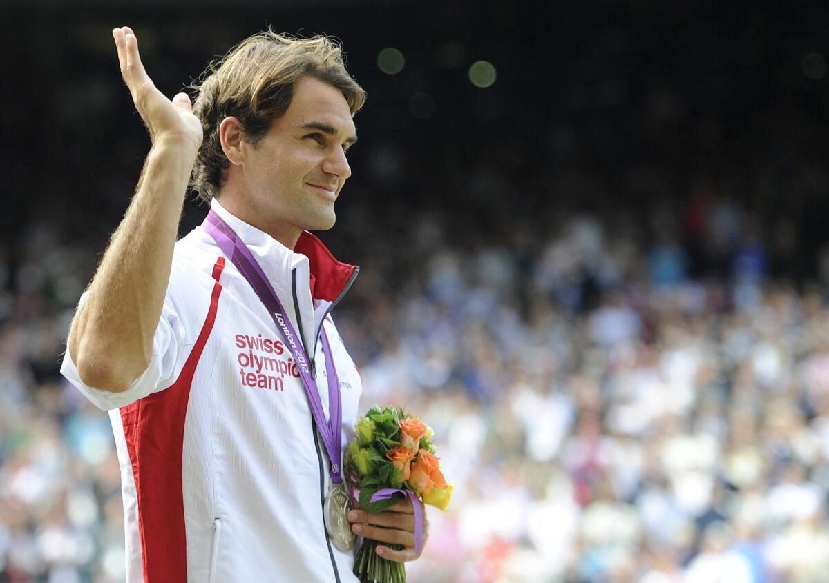 Roger Federer waves to the crowd after losing the Olympic gold medal match to Andy Murray in London in August. In response to an online threat, security has been tightened around Federer in China, where he's playing in an event next week.
