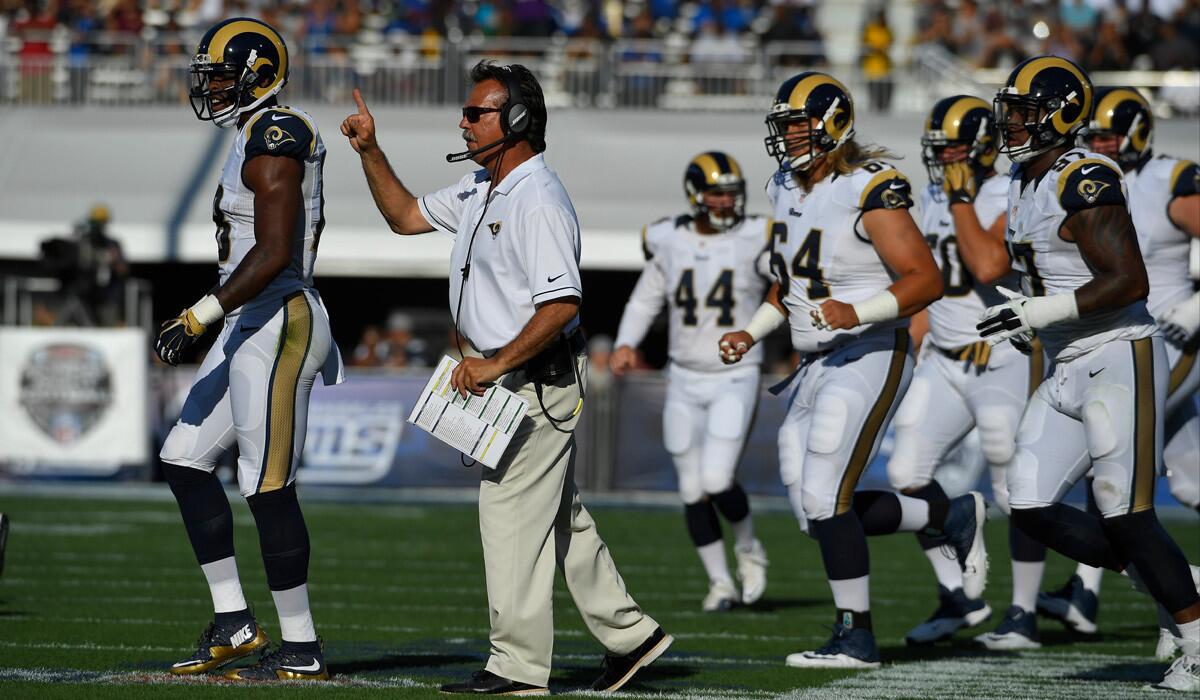 Rams Coach Jeff Fisher calls to his team from the sideline during a preseason game against the Dallas Cowboys on Saturday.