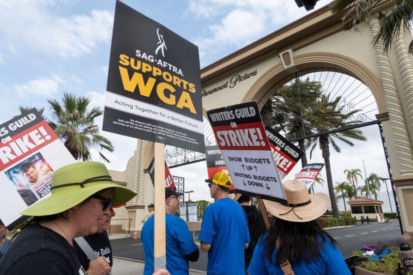 LOS ANGELES, CA - JUNE 06: Writers Guild of America members with support from SAG-AFTRA, strike at Paramount Studios in Los Angeles, CA on Tuesday, June 6, 2023 as the strike enters the sixth week. The Directors Guild of America recently signed a new contract and the screen actors guild SAG-AFTRA has authorized a strike at the end of the month if they cannot come to terms with the studios. (Myung J. Chun / Los Angeles Times)
