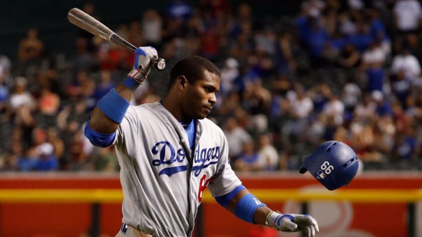 Dodgers outfielder Yasiel Puig (66) swings at his helmet after a ground out against the Diamondbacks on Aug. 16.