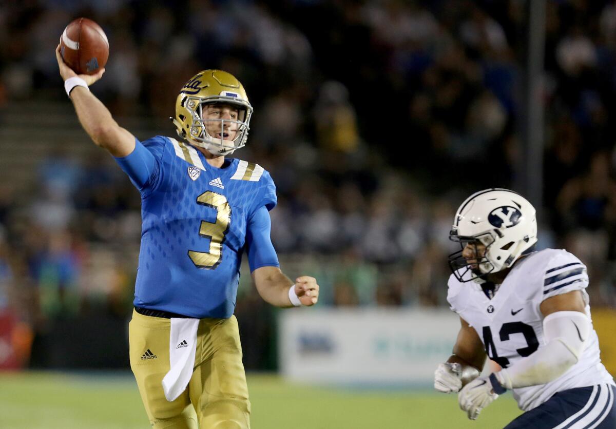 UCLA quarterback Josh Rosen is pressured by BYU linebacker Jherremya Leuta-Douyere into throwing his third interception of the first half.