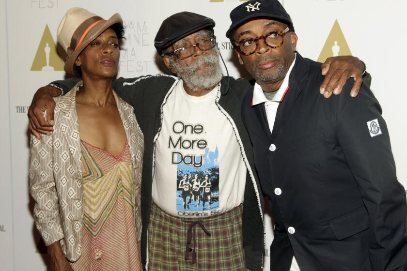 FILE - Director Spike Lee, right, and his with sister, screenwriter Joie Lee, left, appear with their father Bill Lee at a screening of "Do The Right Thing" in New York on June 29, 2014. Bill Lee, a well-regarded jazz musician who accompanied such artists as Bob Dylan, Simon and Garfunkel and Harry Belafonte as well as scoring four of his son Spike’s early films, died Wednesday, May 24, 2023, according to Theo Dumont, a publicist for Spike Lee. He was 94. (Photo by Andy Kropa/Invision/AP, File)