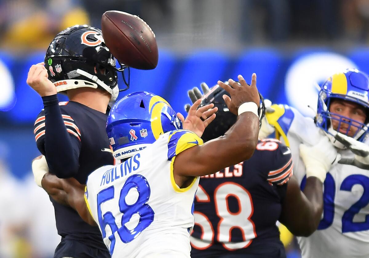 Rams linebacker Justin Hollins forces Bears quarterback Andy Dalton to fumble on fourth down during the first quarter.