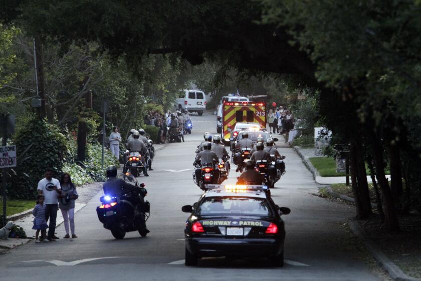 The presidential motorcade makes its way up Iredell Street during President Obama's visit to a fundraiser at actor George Clooney's home in Studio City on May 10, 2012.