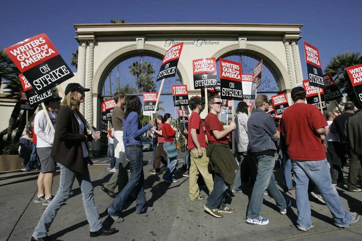 Striking writers walk the picket line outside Paramount Studios on Dec. 13, 2007, in Los Angeles.