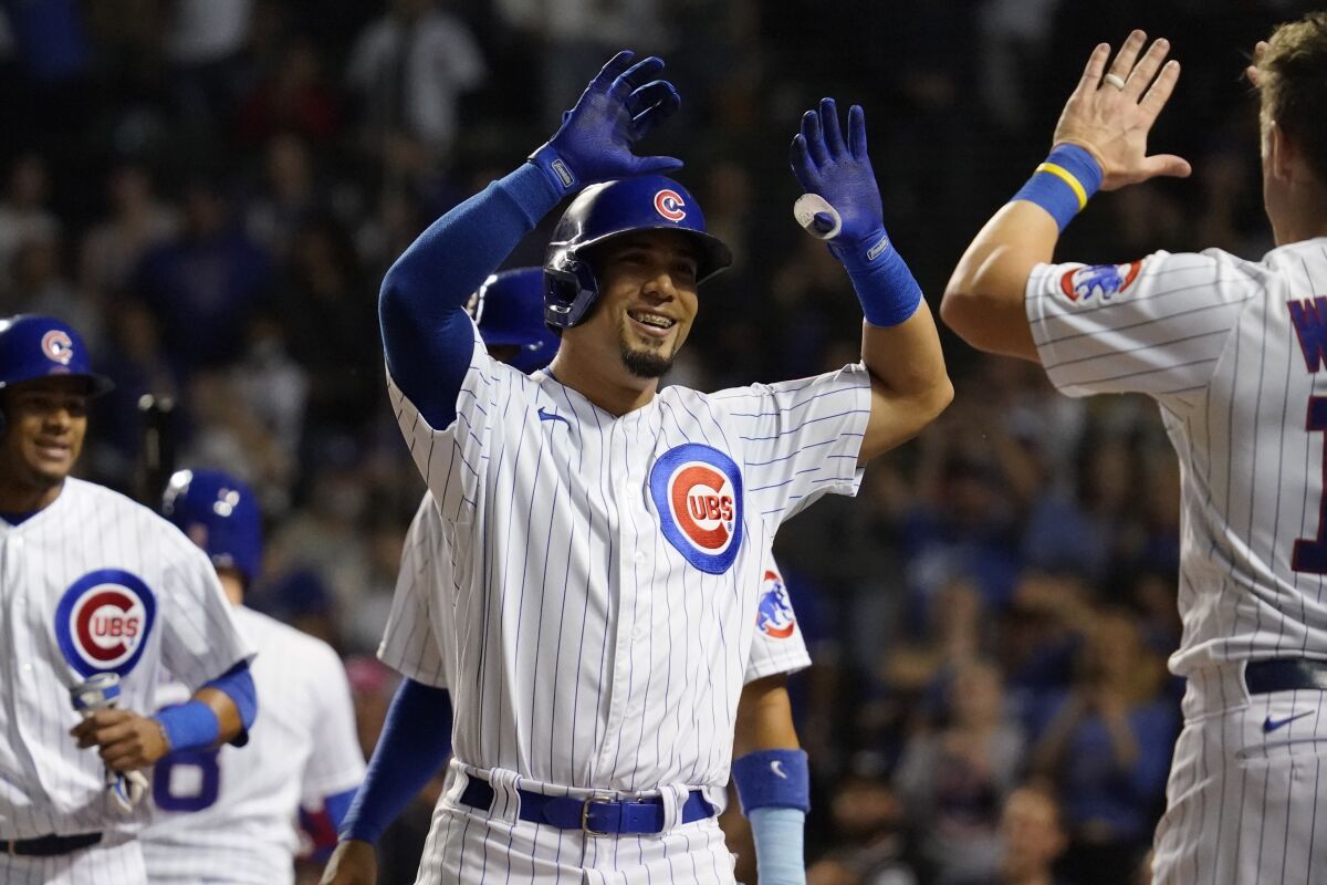Chicago Cubs' Rafael Ortega, center, celebrates with Patrick Wisdom, right, after hitting a three-run home run during the seventh inning of a baseball game against the Pittsburgh Pirates in Chicago, Thursday, Sept. 2, 2021. (AP Photo/Nam Y. Huh)