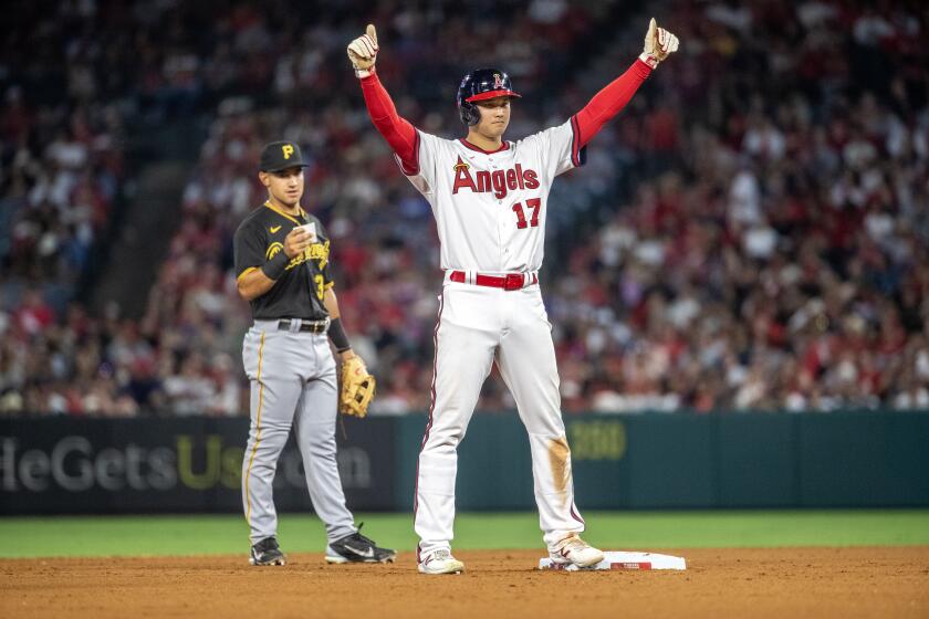 Angels' Shohei Ohtani reacts to a play in a game against the Pittsburgh Pirates on July 21, 2023.