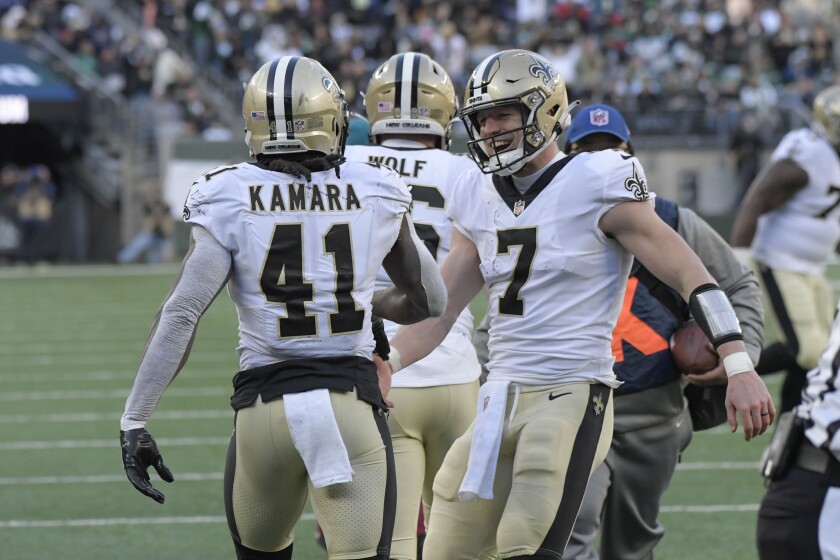 New Orleans Saints quarterback Taysom Hill, right, celebrates with Alvin Kamara (41) after Kamara scored a touchdown during the first half of an NFL football game against the New York Jets, Sunday, Dec. 12, 2021, in East Rutherford, N.J. (AP Photo/Bill Kostroun)
